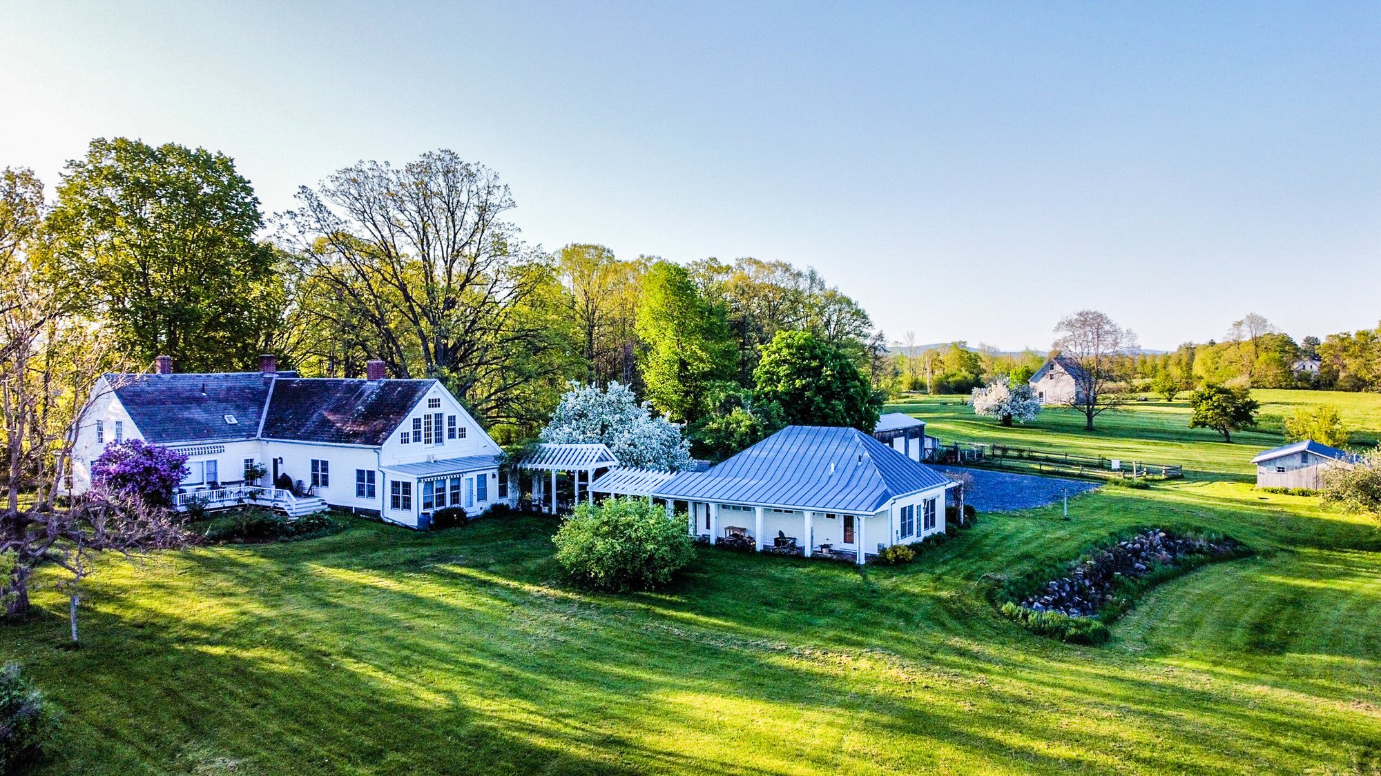 Aerial view of the Whitford House property, guest house, gardens, and surrounding Addison County farmland.